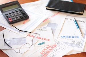 An individual's overdue bills, who now needs the help of Bankruptcy Attorneys in Bloomington IL