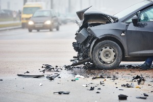 A totaled car from a collision with a truck, needing an Auto Accident Lawyer in Bloomington IL