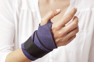 An employee showing their hurt hand, needing a Workers’ Compensation Attorney in Normal IL