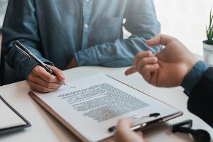 Bankruptcy Attorneys in Peoria IL discussing paperwork with a client