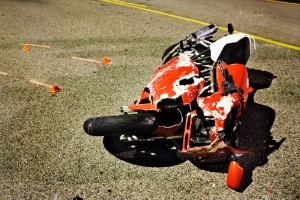 A crashed red motorcycle, where the owner will soon need a Motorcycle Accident Lawyer in Peoria IL